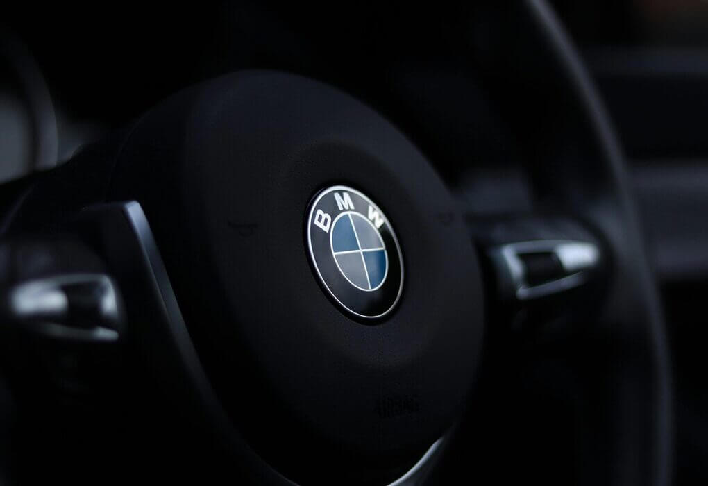 Detailed view of a BMW steering wheel emblem with a stylish depth of field effect.