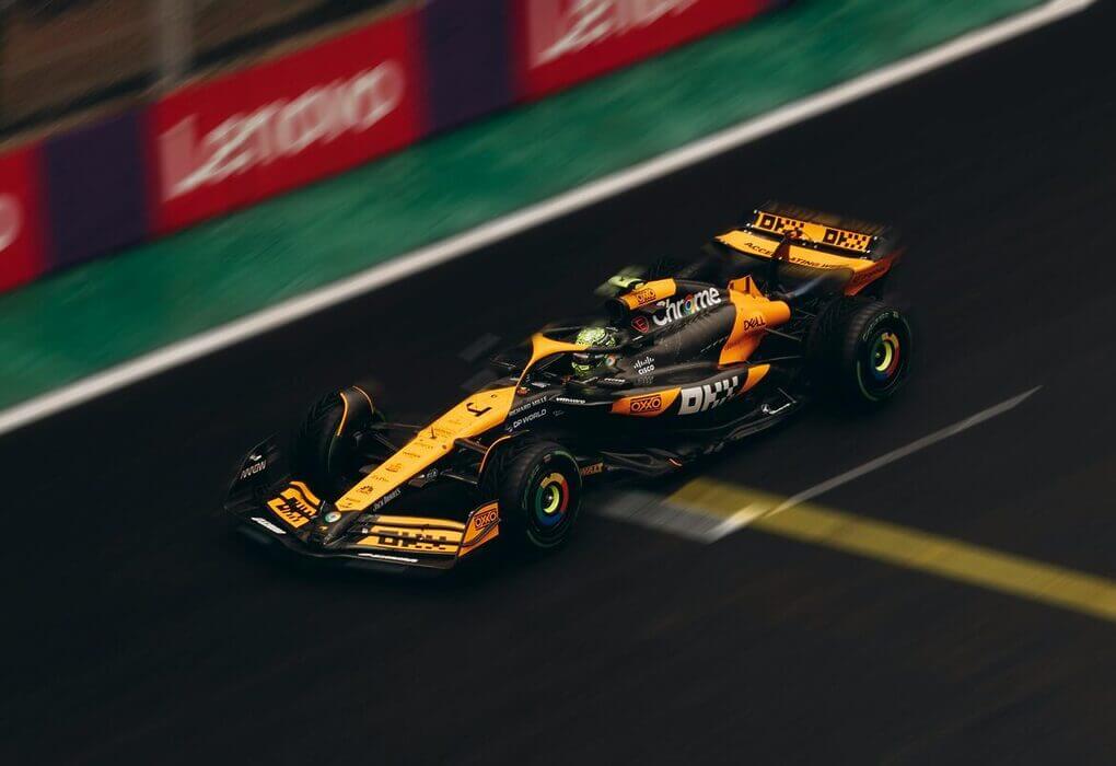 Dynamic shot of a Formula 1 car speeding on a race track during daytime.