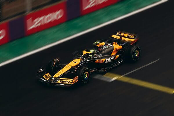 Dynamic shot of a Formula 1 car speeding on a race track during daytime.