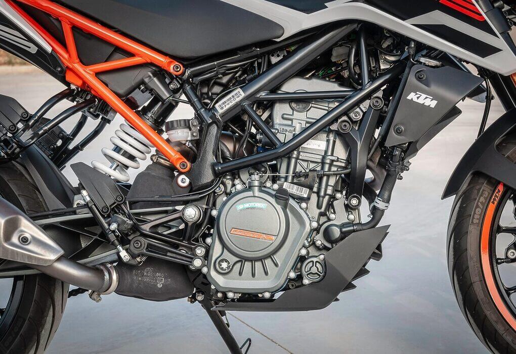 Detailed view of a KTM motorcycle engine showcasing design and machinery outdoors.
