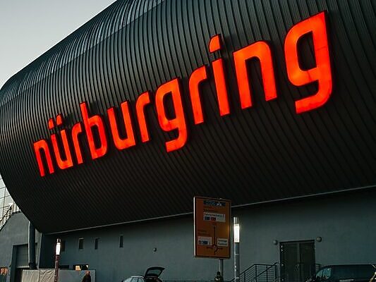 a large building with a neon sign on the side of it