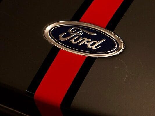 A ford logo with a red racing stripe.
