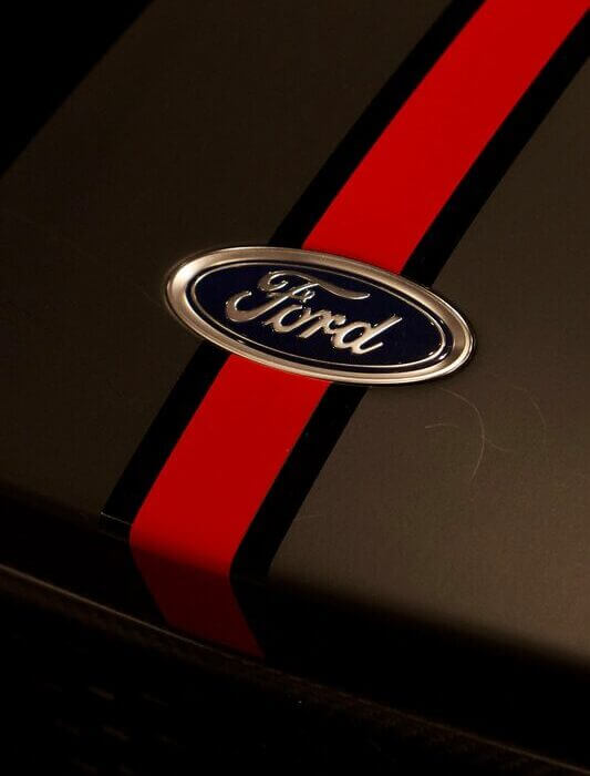 A ford logo with a red racing stripe.