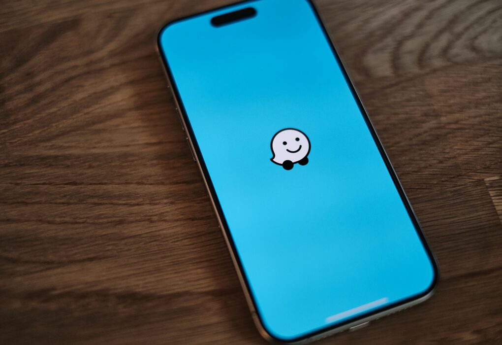 A phone with a sticker of a smiley face on it
