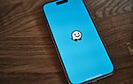 A phone with a sticker of a smiley face on it