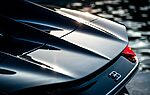 Close-up of a luxury Bugatti supercar reflecting elegance in Marbella, Spain.