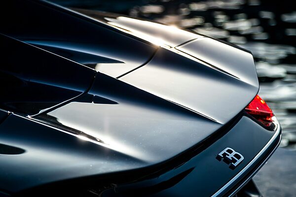 Close-up of a luxury Bugatti supercar reflecting elegance in Marbella, Spain.