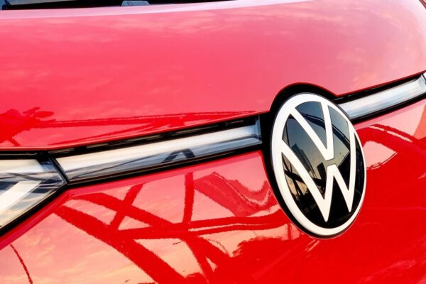 Des modèles Volkswagen alignés devant une usine du groupe lors d’une présentation industrielle.