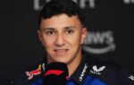 Isack Hadjar en tenue de pilote dans le paddock de Formule 1.